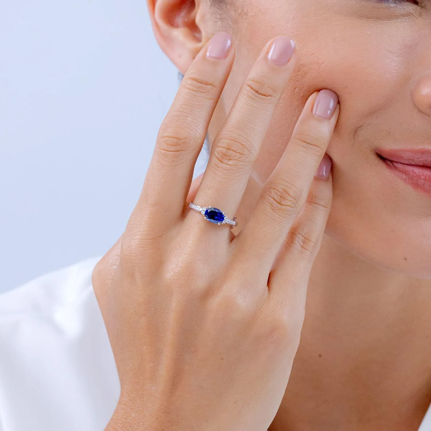 Angara Lab Grown Horizontally Set Oval Sapphire Solitaire Ring with Trio Lab Diamond Accents in Silver / 14K Solid Gold/Platinum | September Birthstone, Birthday, Anniversary Jewelry Gift for Women