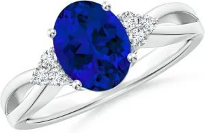 Angara Lab Grown Solitaire Oval Blue Sapphire Split Shank Ring with Trio Lab Diamonds in Silver / 14K Solid Gold/Platinum | Birthday, Engagement, Anniversary, Wedding Jewelry Gift for Women