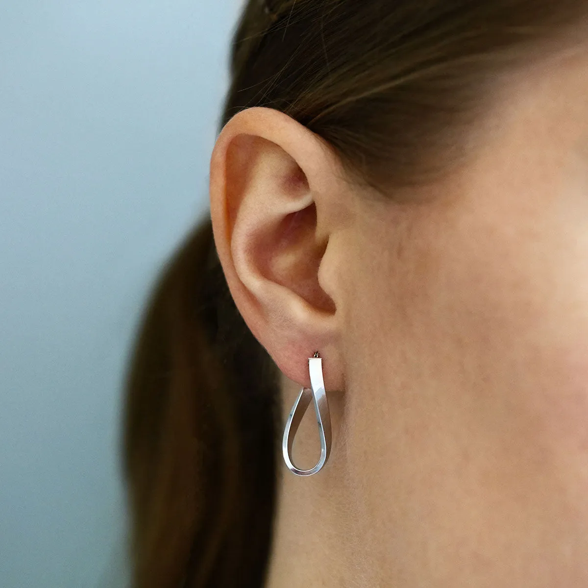 Soleil Collection 10.5mm x 26.5mm Twisted Oval Hoop Creole Earrings | 9K White Gold