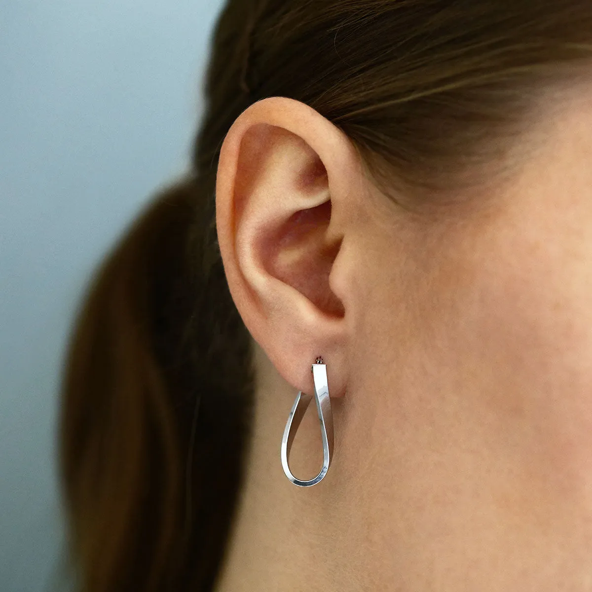 Soleil Collection 10.5mm x 26.5mm Twisted Oval Hoop Creole Earrings | 9K White Gold